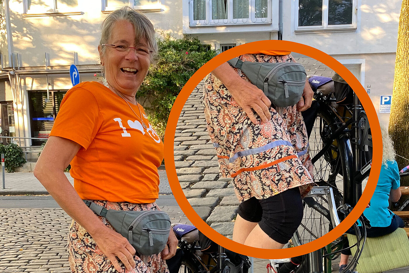 Angelika im orangenen ADFC-T-Shirt mit dem Slogan "I love Fahrrad" präsentiert ihren selbstgeschneiderten Rock mit den ADFC-Streifen in orange und blau